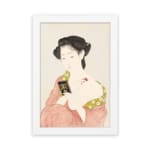 Vintage Japanese wall art featuring a woman in traditional dress holding a book with soft red and green patterns. hung on the wall