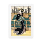Vintage wall art of a Japanese woman in a black kimono with floral sash, standing before a traditional wooden building. hung on the wall