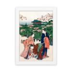 Vintage Japanese wall art of women in kimonos under cherry blossom trees with a temple in the background. hung on the wall
