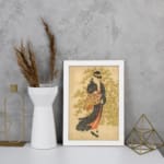 Vintage Japanese wall art of a woman in a kimono with floral patterns, set against a soft green and beige background. displayed on the wall in a white frame