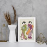Vintage Japanese wall art with two women in kimonos, detailed patterns, and soft, rich colors. displayed on the wall in a white frame