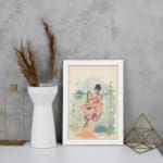 Vintage wall art of a woman in a pink dress sitting on a swing with a scenic landscape, framed in white for a classic and elegant look. displayed on the wall