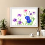 Infidu Vintage Floral Wall Art with blue, purple, and white flowers, green stems, and a white frame on a light background. displayed on the wall
