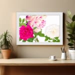Infidu Vintage Floral Wall Art with pink, cream, and white flowers, green leaves, and a white frame on a white background. displayed on the wall