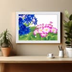 Infidu Vintage Floral Wall Art with deep blue and pink flowers, bright green leaves, a white background, and a white frame for a classic touch. displayed on the wall