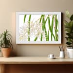 Vintage floral wall art with white orchids and green leaves, framed in white for a classic and elegant look. displayed on the wall