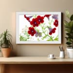 Vintage floral wall art with red and purple trumpet flowers, green leaves, and a white frame on a white background. displayed on the wall