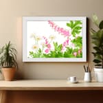 Vintage floral wall art with delicate pink and white flowers, green leaves, and a white frame on a white background. displayed on the wall