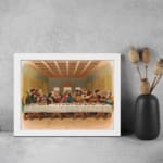 Vintage wall art of the Last Supper with Jesus and his disciples in a detailed, warm-toned biblical setting. displayed on the wall in a white frame