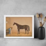 Infidu vintage wall art featuring an elegant horse standing in a cozy stable, with soft brown and beige tones, a small window, and rustic details. displayed on the wall art in a white frame