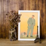 Vintage art of a man in a green suit standing with a bulldog against a warm orange and yellow background. displayed on the wall in a white frame