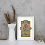 Vintage Celtic wall art with intricate medieval patterns in blue, green, gold, and red, featuring swirling shapes and mythical elements. displayed on the wall in a white frame