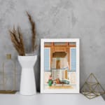 Vintage architectural wall art with historic figures, blue and gold tones, and a white frame for a classic and elegant look. displayed on the wall