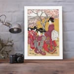 Vintage Japanese wall art with elegantly dressed women in kimonos, intricate patterns, and cherry blossom trees in a serene setting displayed on the wall in a white frame