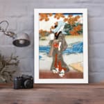 Vintage Japanese wall art with a woman in a kimono near a river, detailed autumn leaves, and a serene landscape in classic Ukiyo-e style. displayed on the wall