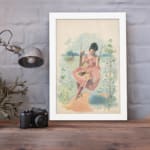 Vintage wall art of a woman in a pink dress sitting on a swing with a scenic landscape, framed in white for a classic and elegant look. displayed on the wall
