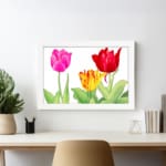 Infidu Vintage Floral Wall Art with pink, red, and yellow tulips, green leaves, and a black frame on a white background. displayed on the wall