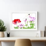 Vintage floral wall art with red, purple & white flowers, green leaves, and a black frame on a white background. displayed on the wall