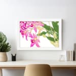 Vintage floral wall art with pink orchids, yellow centers, green leaves, and a white frame on a white background. displayed on the wall