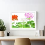 Infidu Vintage Floral Wall Art with orange, pink, and white flowers, green leaves, and a white frame on a white background. displayed on the wall