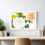 Infidu Vintage Floral Wall Art with yellow, orange, and white roses, green leaves, and a white frame on a white background. displayed on the wall