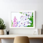 Infidu Vintage Floral Wall Art with white, purple, and pink flowers, green leaves, and a white frame, adding a classic touch to any décor. displayed on the wall