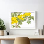 Infidu Vintage Floral Wall Art with yellow flowers, green leaves, and a white frame on a white background, adding a classic botanical touch. displayed on the wall.