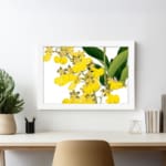 Vintage floral wall art with yellow flowers and green leaves in a white frame. displayed on the wall