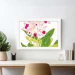Vintage floral wall art with soft pink orchids, dark pink centers, green leaves, and a white frame on a white background. displayed on the wall