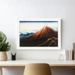 Vintage mountain landscape wall art with red, brown, and blue tones, featuring a striking reddish-brown mountain, blue sky, and white frame. displayed on the wall