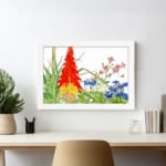 Infidu Vintage Botanical Wall Art with red, yellow, pink, and blue flowers, green leaves, and white background, creating a fresh and elegant look. displayed on the wall in a white frame