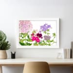 Infidu Vintage Floral Wall Art with soft pink, purple, and deep red flowers, green leaves, and a white background for a timeless, elegant look. displayed on the wall in a white frame