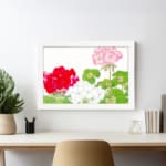 Infidu Vintage Floral Wall Art with red, white, and pink flowers, green leaves, and a white frame on a white background. displayed on the wall