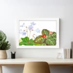 Infidu Vintage Floral Wall Art with light purple flowers, a small red flower, and dark green leaves on a white background. displayed on the wall