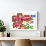 Vintage wall art featuring brown leaves with pink patterns and delicate blue, pink, and white flowers on a white background, framed in white. displayed on the wall