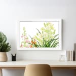 Infidu vintage wall art with green, pink, white, and orange flowers, lush leaves, and a black frame on a white background for a timeless look. displayed on the wall art in a white frame
