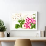 Infidu vintage wall art with pink and white flowers, green leaves, and a white frame on a white background for a timeless and elegant look. displayed on the wall in a white frame