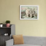 Vintage wall art featuring a polar bear in an icy Arctic landscape with icebergs, explorers, and a soft blue and pink sky. displayed on the wall in a white frame