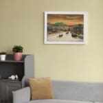 Infidu vintage wall art of a winter scene with horse-drawn sleighs passing through a snowy town, featuring warm sky tones and a peaceful landscape. displayed on the wall art in a white frame