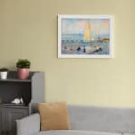 Infidu vintage wall art featuring a peaceful seaside scene with a sailboat on calm waters, people on the beach, and soft pastel colors in the sky. displayed on the wall art in a white frame