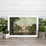 Infidu vintage wall art featuring the Taj Mahal with earthy tones of green, beige, and brown, framed by lush trees and a long pathway leading to the monument. displayed on the wall art in a black frame