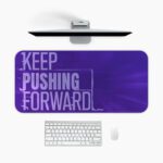 Infidu desk pad with bold “Keep Pushing Forward” quote on purple background and vintage art-inspired design.