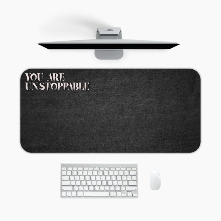 Infidu black desk pad with bold white "YOU ARE UNSTOPPABLE" text on a textured black background.