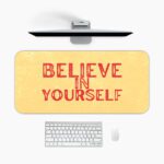 Infidu desk pad with bold red Believe in Yourself text on a soft yellow background and subtle vintage texture.