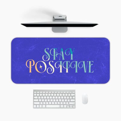 Infidu royal blue desk pad with “Stay Positive” quote in colorful pastel font and marble texture background.