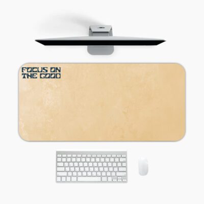 Infidu beige desk pad with motivational “Focus on the Good” quote in bold black text on a soft tan background.