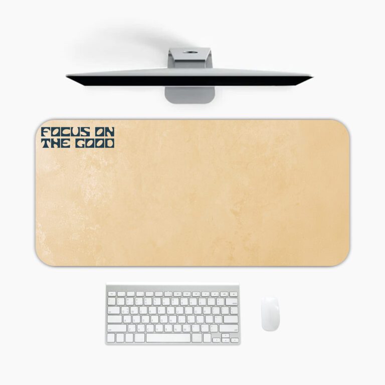 Infidu beige desk pad with motivational “Focus on the Good” quote in bold black text on a soft tan background.