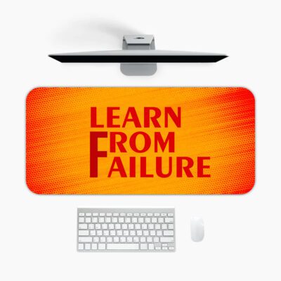 Infidu desk pad with bold red "Learn From Failure" quote on an orange to red gradient background.
