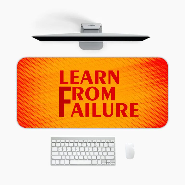 Infidu desk pad with bold red "Learn From Failure" quote on an orange to red gradient background.