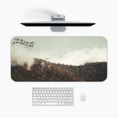 Infidu Misty Mountain Desk Pad featuring forested hills with fog, earthy colors, and the inspirational quote "Live as love did, and be made in love."
